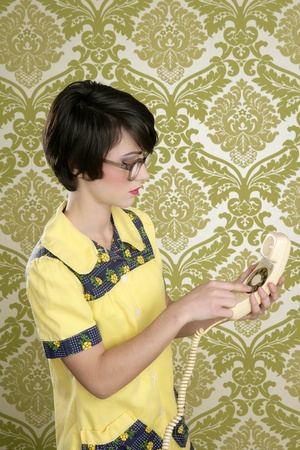 nerd housewife retro woman dial vintage wired phone 70s wallpaperの写真素材
