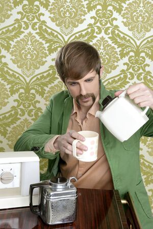 geek retro man drinking tea coffee vintage teapot in wallpaperの写真素材