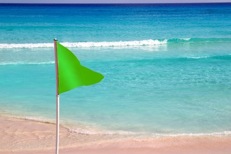 Green beach flag in  good beach weatherの写真素材