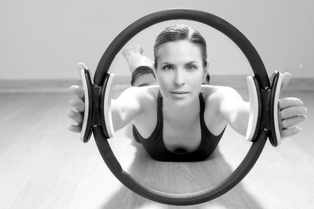 magic pilates ring woman aerobics sport gym exercises on wooden floorの写真素材