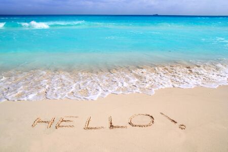 Hello message spell written in tropical beach sand Caribbean turquoise seaの写真素材