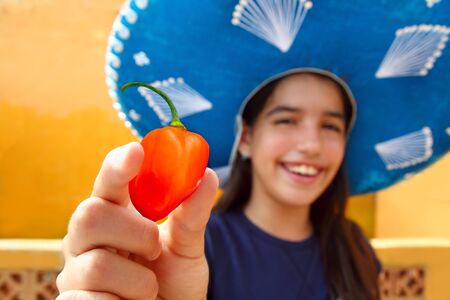 Mexican girl show habanero orange hot chili pepper mexican hatの写真素材
