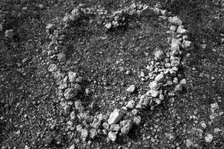 black and white heart shape stones on soil romantic and dramaticの写真素材