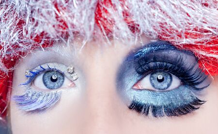 asymmetrical christmas concept eye makeup winter red silver macro closeupの写真素材