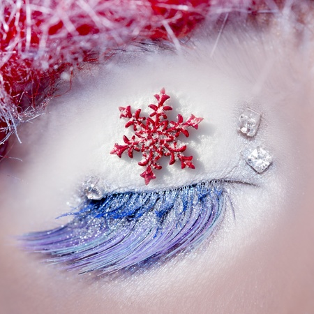 christmas star concept eye makeup winter red silver macro closeupの写真素材