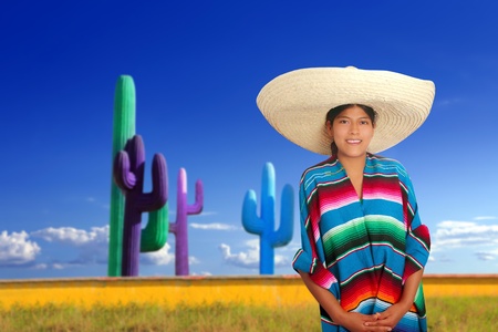 Mexican poncho girl with big sombrero in cactus background of Mexicoの写真素材
