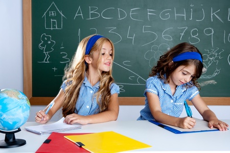 classroom with two kids students cheating on test exam at schoolの写真素材