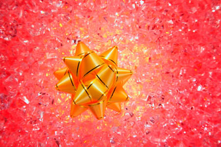 christmas gift golden ribbon on red ice backgroundの写真素材