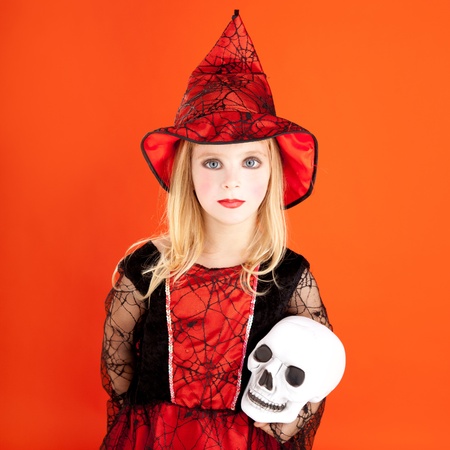Halloween kid girl costume on orange backgroundの写真素材