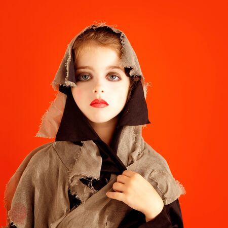 Halloween kid girl costume on orange backgroundの写真素材