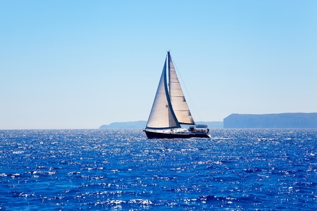 Blue Mediterranean sailboat sailing in perfect ocean at San Antonio capeの写真素材