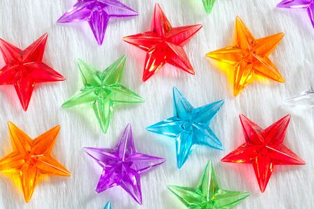 christmas colorful glass stars over white fur background as snowの写真素材