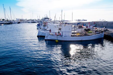 fishing boats at sunset in Formentera marina at Mediterranean Balearic islandsの写真素材