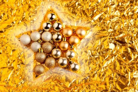 christmas baubles in star shape on golden backgroundの写真素材
