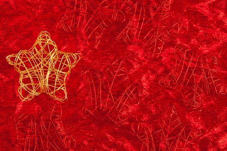 christmas golden star of wire over red backgroundの写真素材