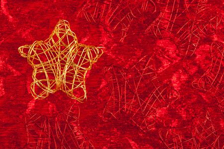christmas golden star of wire over red backgroundの写真素材
