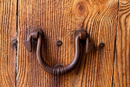Ibiza traditional rusted iron door handle on weathered wood