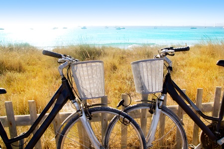 bicycles couple parked in Formentera beach of Illetesの写真素材
