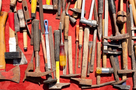 hand tools used rusty iron aged and grunge on a red backgroundの写真素材