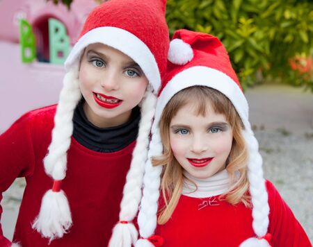 Christmas santa costumer kid girls makeup portrait smiling outdoorの写真素材