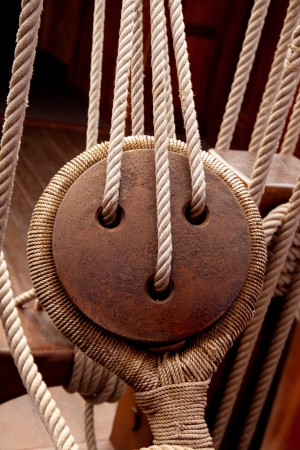 Ancient wooden sailboat pulleys and ropes detail の写真素材