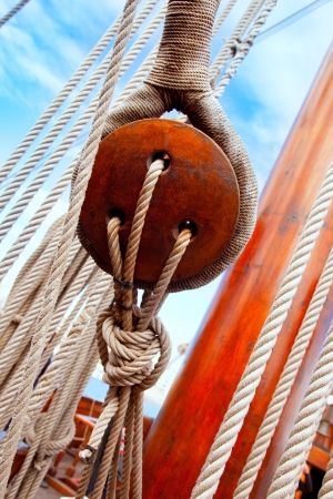Ancient wooden sailboat pulleys and ropes detail 