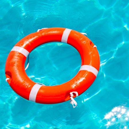 Buoy orange round floating in perfect tropical beach with turquoise water