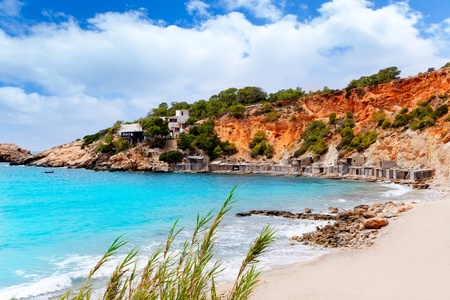 Cala d Hort Ibiza beach with traditional wood boat mooring in Balearic islandのeditorial素材