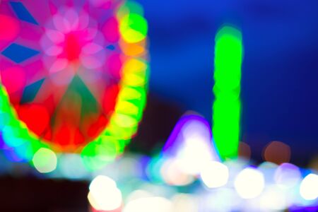 colorful ferrys wheel fairground night lights over blue skyの写真素材