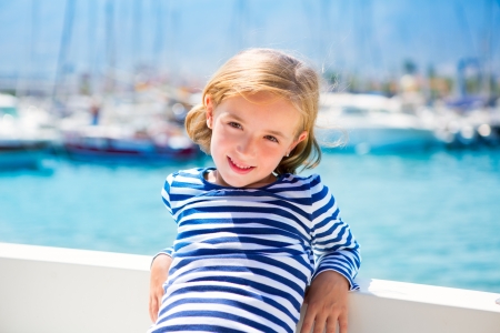 child kid girl in marina boat on summer vacations in Mediterraneanの写真素材