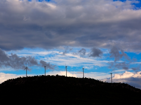 Sunset mountain with electric windmills aerogenerators backlightの写真素材
