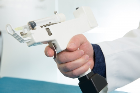 mesotherapy gun electronic with syringe on doctor handsの写真素材