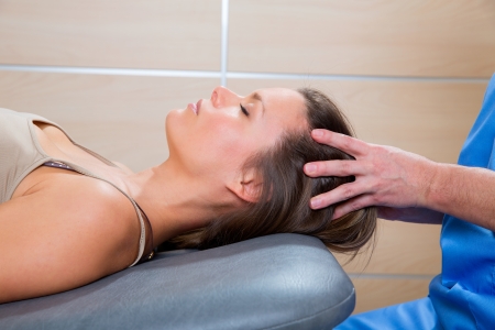 Massage therapy on cranial hear area by therapist to a beautiful womanの写真素材