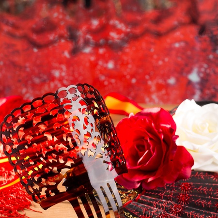 Flamenco comb fan and roses typical from Spain Espana on red backgroundの写真素材
