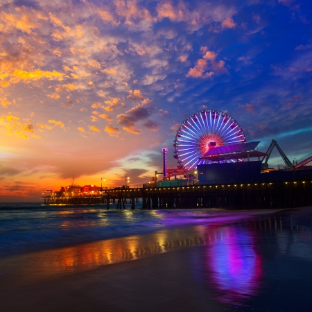 Santa Monica California sunset on Pier Ferrys wheel and reflection on beach wet sandの写真素材