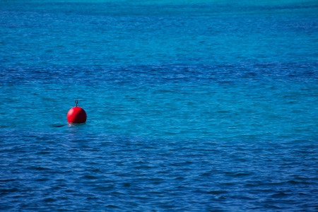red buoy  floating in  blue mediterranean sea perspectiveの写真素材
