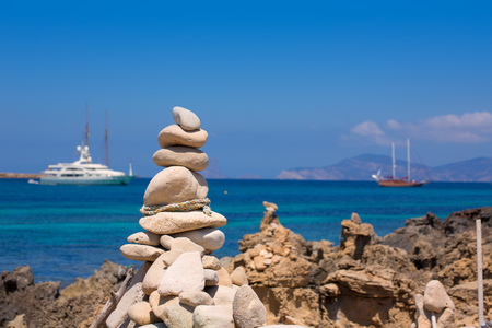 Stone figures on beach shore of Illetes beach in Formentera Mediterranean Balearic Islandsの写真素材