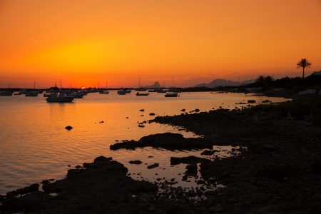 Formentera sunset in Estany des Peix boats with Ibiza Es vedra in Backgroundの写真素材
