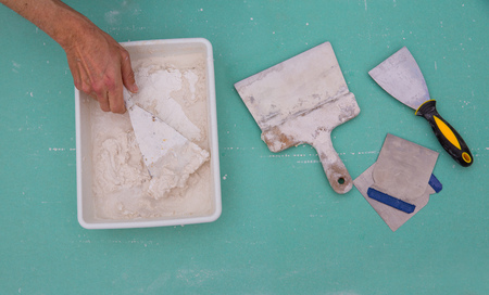 Platering tools for plaster like plaste trowel spatula on green drywall plasterboardの写真素材