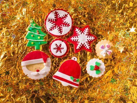 Christmas cookies Xmas tree Santa snowflake on golden backgroundの写真素材