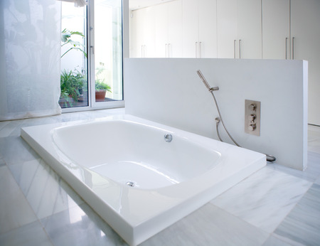 Modern white house bathroom bathtub with marble floor and courtyard skylightの写真素材