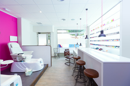 Nail saloon and pedicure chair spa modern with nail polish colorful in a row on white backgroundの写真素材