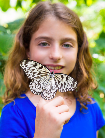 Girl holding finger Rice Paper butterfly Idea leuconoe in outdoorの写真素材