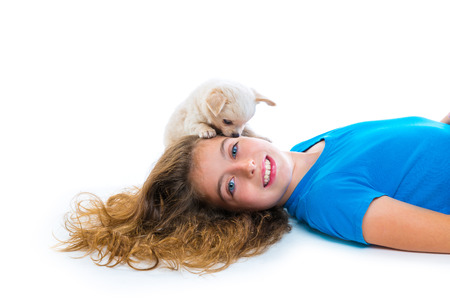 relaxed kid girl and puppy chihuahua dog lying happy on white backgroundの写真素材