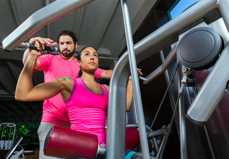 Lat Lateral dorsal pulldown machine upper back woman with personal trainer man