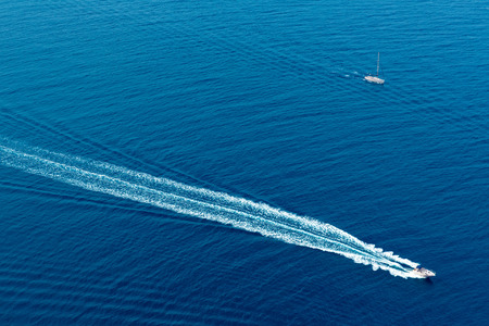 Boat surf foam aerial from prop wash in blue Majorca mediterranean seaの写真素材