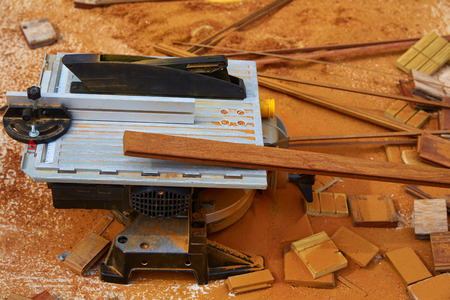 Circular table saw carpenter tool and sawdust in deck installation