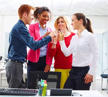 Happy business team toasting with champagne celebrating the success