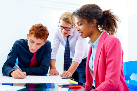 Multi ethnic teamwork of young business people meeting working at office