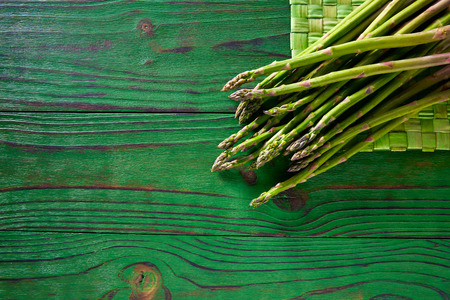 green asparagus fresh on wooden monochrome rustic tableの写真素材